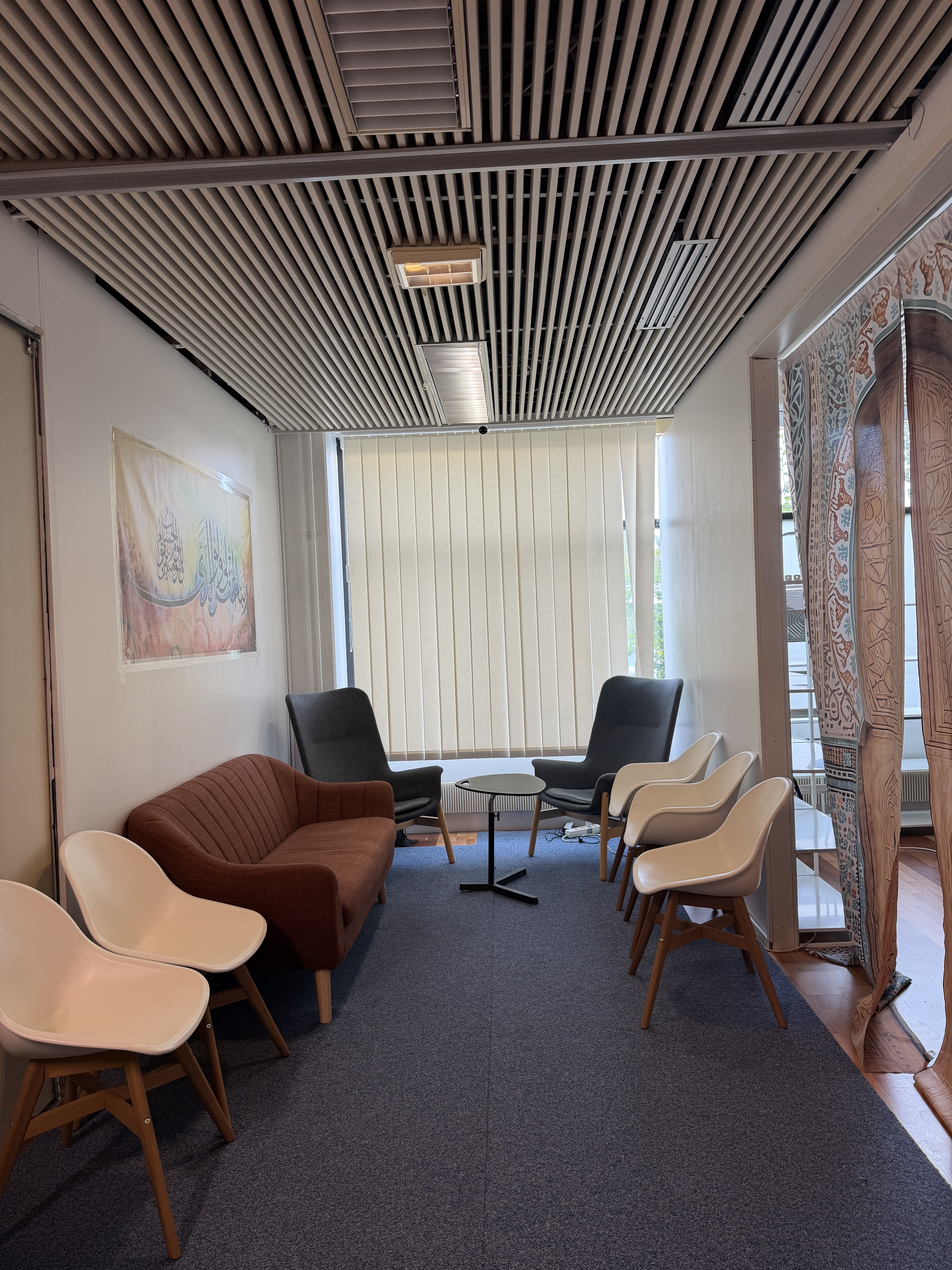 A seating area at EMC's business lounge, with a sofa, armchairs, and a coffee table