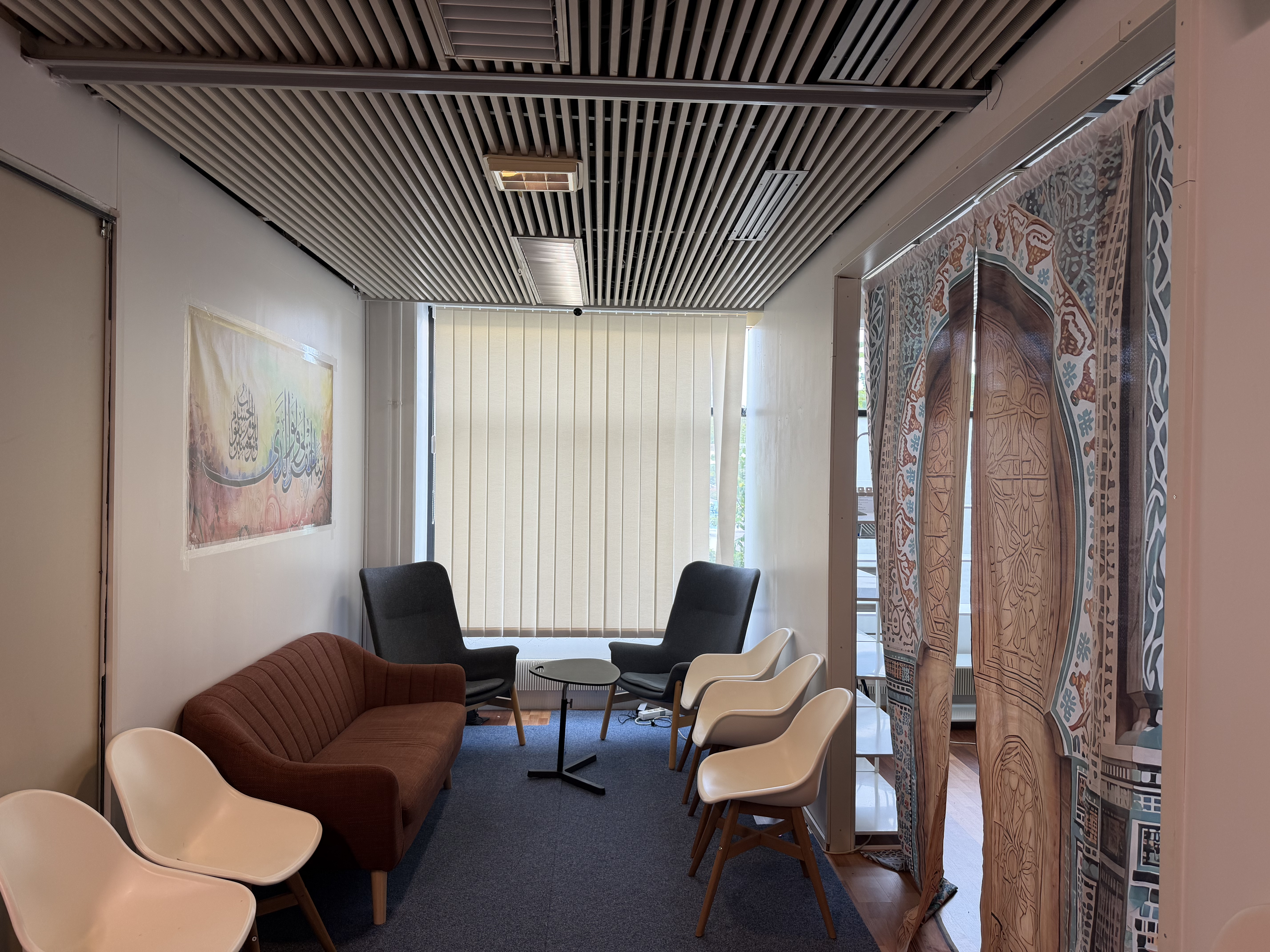 A seating area at EMC's business lounge, with a sofa, armchairs, and bar stools