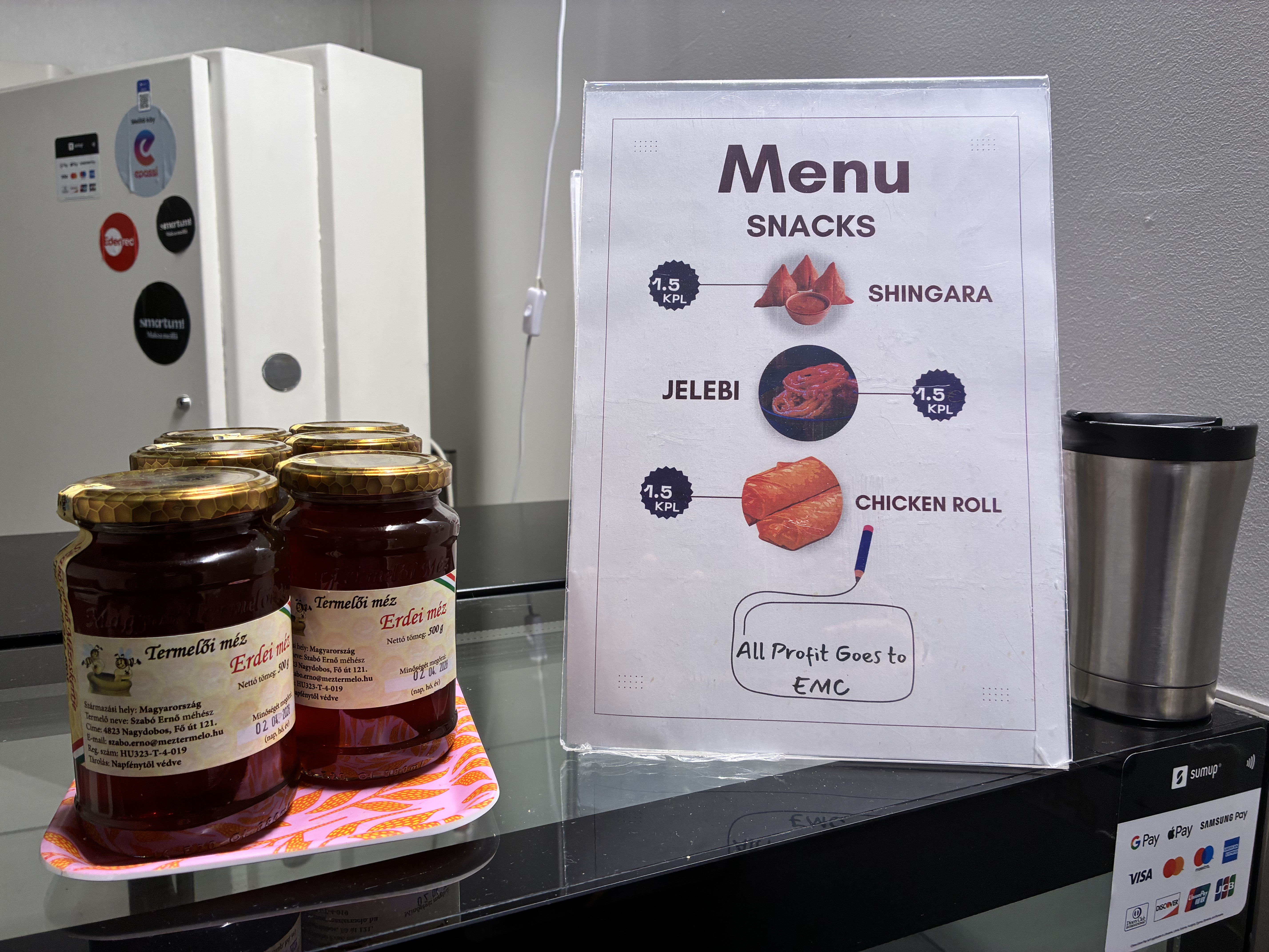 A food display counter with a snacks menu at EMC's business lounge