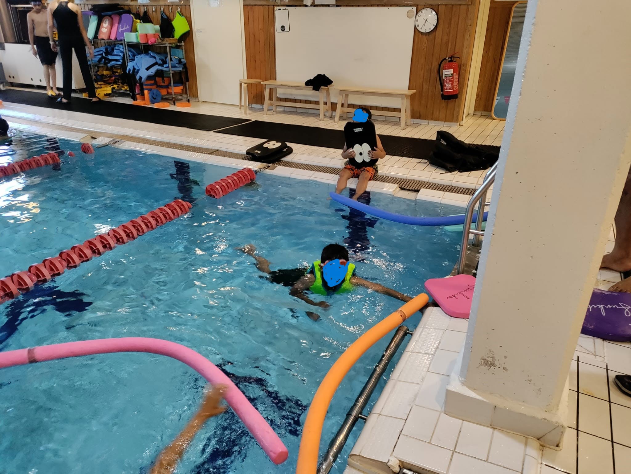 A child swimming with a flotation aid during an EMC swimming session