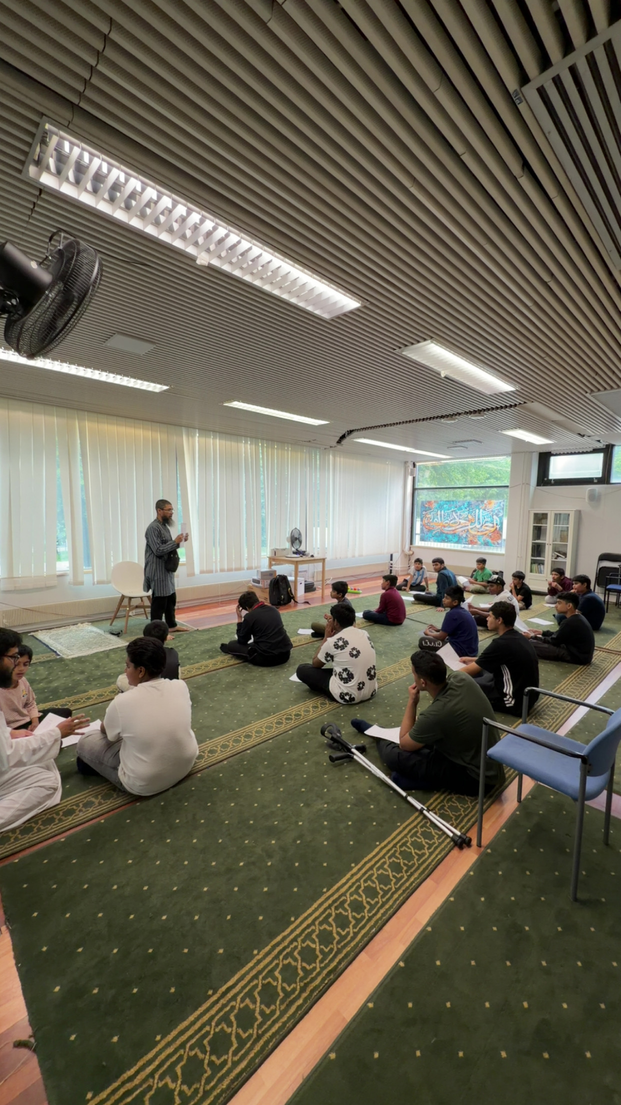 Teenage boys sitting in a circle during an EMC youth study session